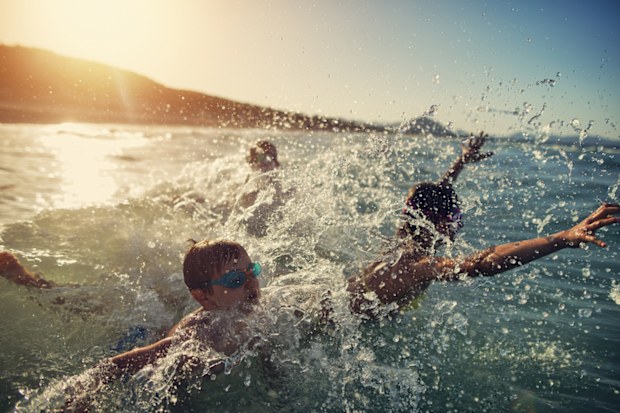 kids swimming at beach