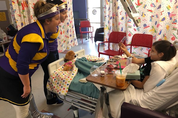 Lorelei being visited by the Starlight captains in hospital during dialysis. 