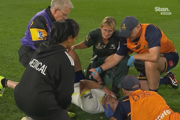 Referee Angus Gardner receives medical attention during the round six Super Rugby match.