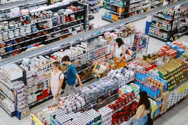 Overhead image of people buying in the large supermarket.