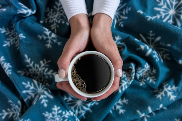 Woman's hands holding black coffee