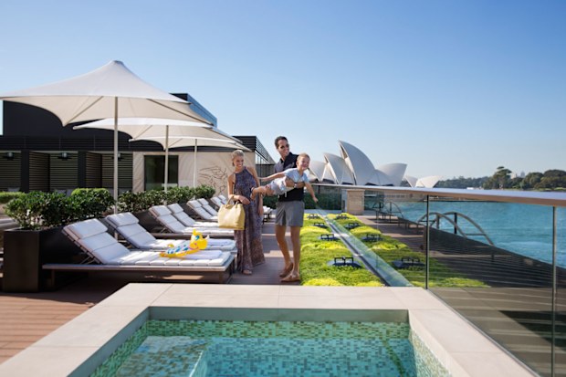 Family on sunbeds at the Park Hyatt Sydney rooftop