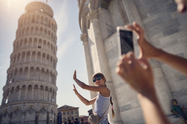 Woman taking photos at the Leaning Tower of Pisa