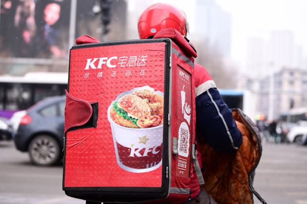 A delivery staff of the KFC rides an electric bicycle along a road on January 8, 2020 in Shenyang, Liaoning Province of China. 