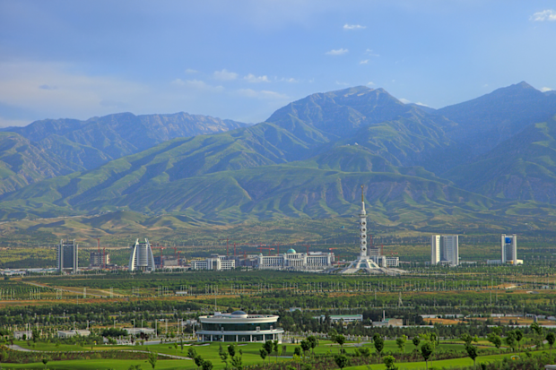 Ashgabat, Turkmenistan: Constitution monument and government buildings on Archabil avenue with mountains in the background