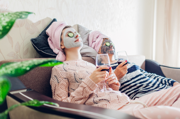 Two women sip wine and get facials