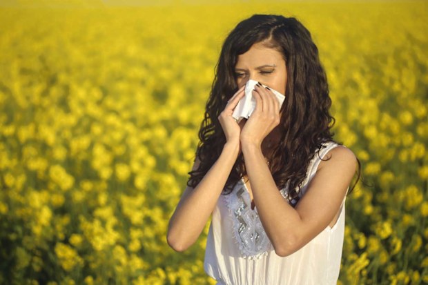 Woman in a field of flowers, hayfever
