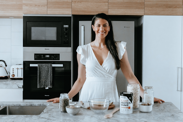 Stephanie Rice in the kitchen making a recipe with PranaOn plant based protein powder