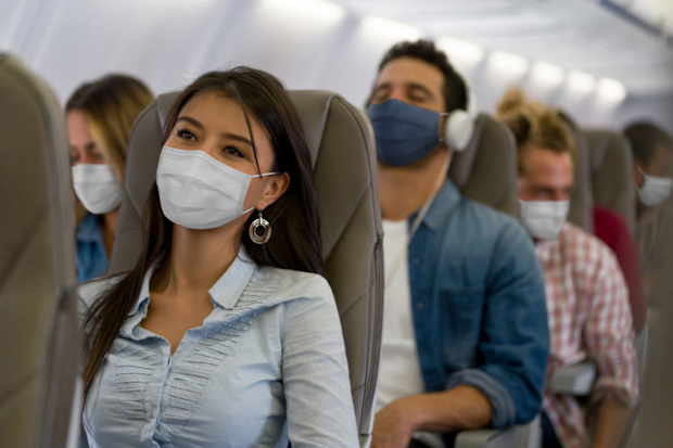 People wearing face masks on plane