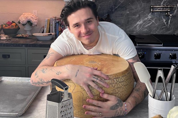 Brooklyn Peltz Beckham hugs a wheel of cheese