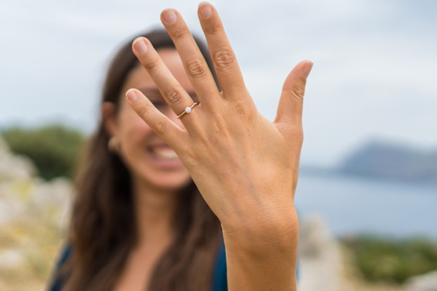 Stock image of a woman with an engagement ring on her finger