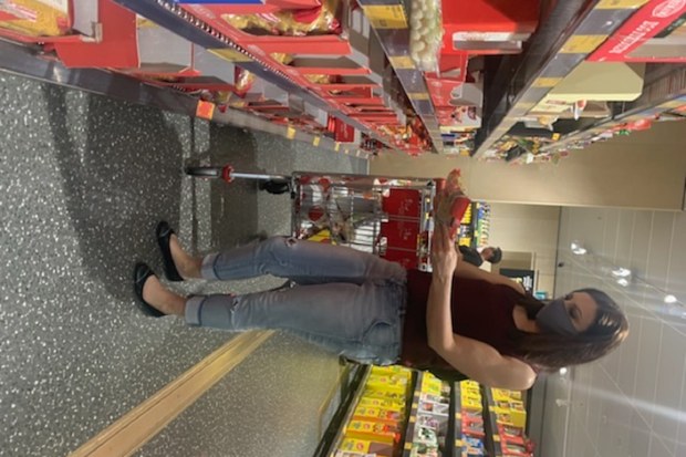 Jo Abi shopping at Aldi comparing products.