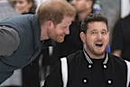 Prince Harry, the Duke of Sussex, jokes with singer Michael Buble, right, as he prepares to take a shot  during an Invictus Games wheelchair curling training camp in Vancouver, British Columbia, Friday, Feb. 16, 2024. (Darryl Dyck/The Canadian Press via AP)