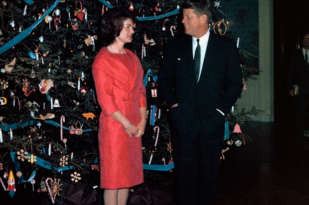 John F. Kennedy and Jackie Kennedy pose with the White House Christmas tree in 1961.