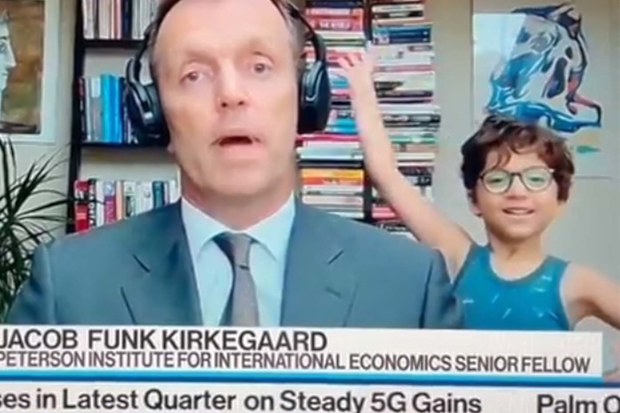 Live TV interview with man being interrupted by his child waving his hands around in the background