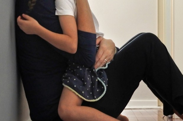 Sad mother hugging daughter