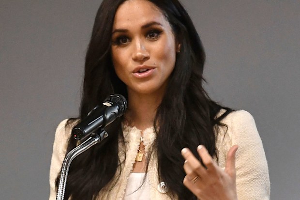Britain's Meghan, Duchess of Sussex, speaks during a school assembly as part of a surprise visit to the Robert Clack Upper School in Dagenham, Essex, in eastern London, to celebrate International Women's Day, Friday, March 6, 2020