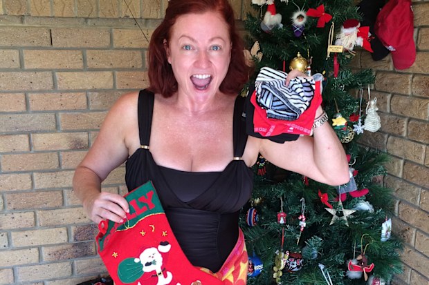 Shelly Horton with outdoor Christmas tree.