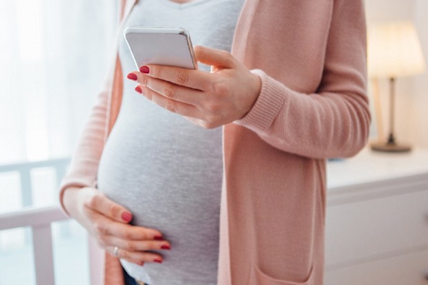 Pregnant woman holding belly.