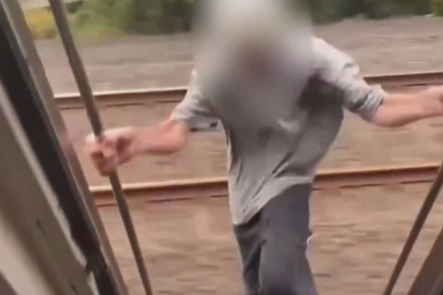 Unknown teenager hands from train in dangerous social media trend 