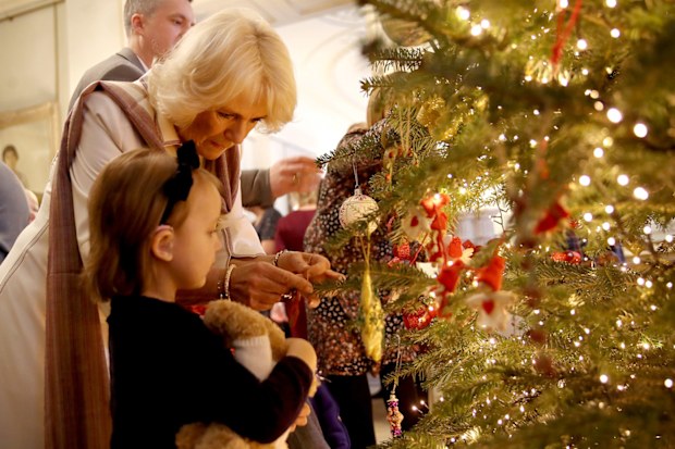 Camilla, Duchess of Cornwall decorates the Clarence House Christmas tree with children from various London charities in 2017.