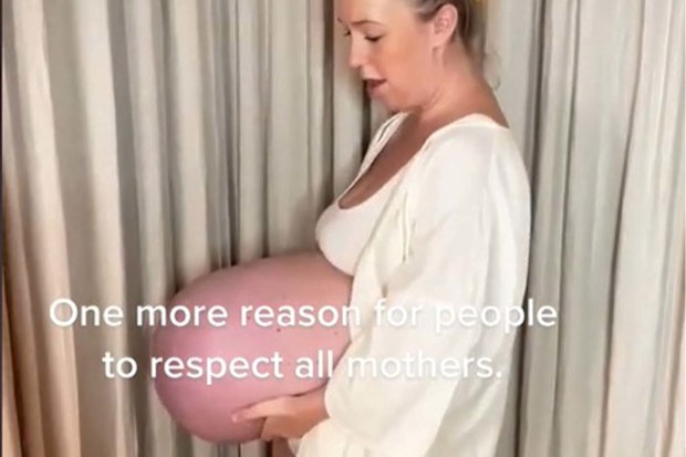 Expectant mum holding up her pregnancy belly.