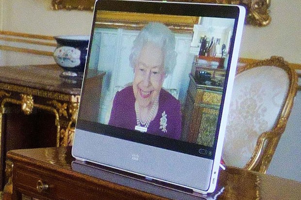 Queen Elizabeth II, in residence at Windsor Castle, appears on a screen via videolink, during a virtual audience to receive Fahad bin Mohammed Al-Attiyah, Ambassador of Qatar, and Sheikha Raya Khalifa Abdulla Khalifa Al Khalifa (L), at Buckingham Palace on March 22, 2022 in London, England