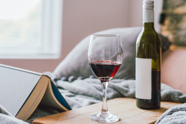 Wine glass and bottle at bedside