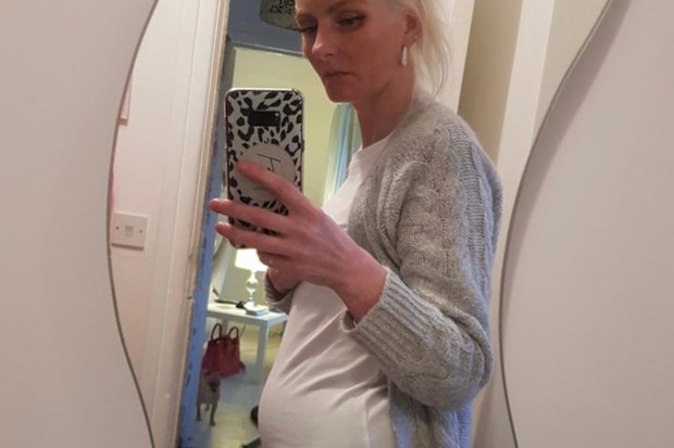 Tess taking a photo of the lump in a mirror at her home.