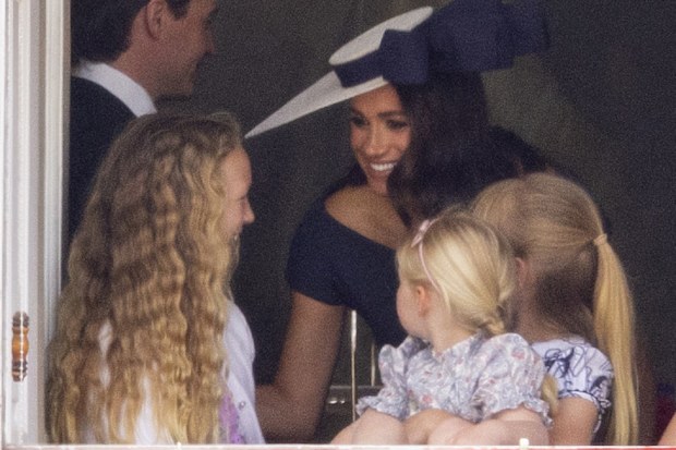 Meghan Markle with Savannah Phillips and Mia Tindall in the  Major General's office overlooking The Trooping of the Colour on Horse Guards Parade.