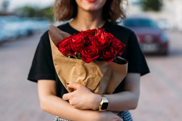 Young woman holding red roses