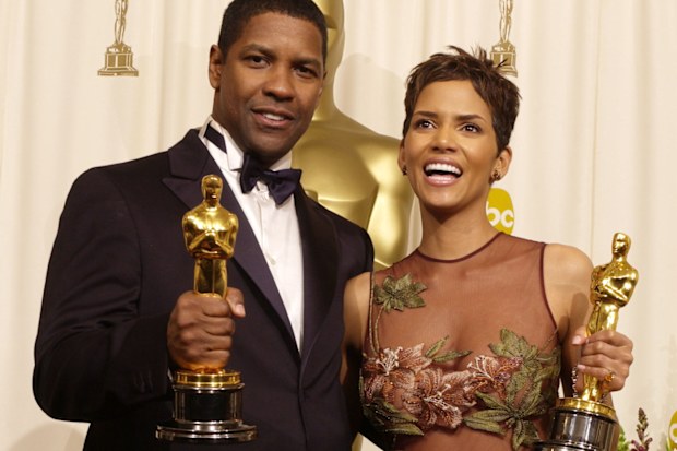Actor and Actress in a Leading Role winners Denzel Washington and Halle Berry pose with their Oscars backstage in 2002.