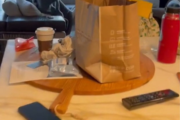 McDonald's paper bag and other items lying on a counter in a messy way