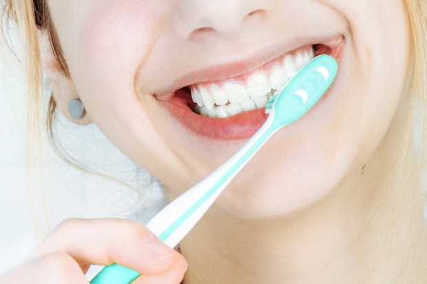Close up of woman brushing teeth