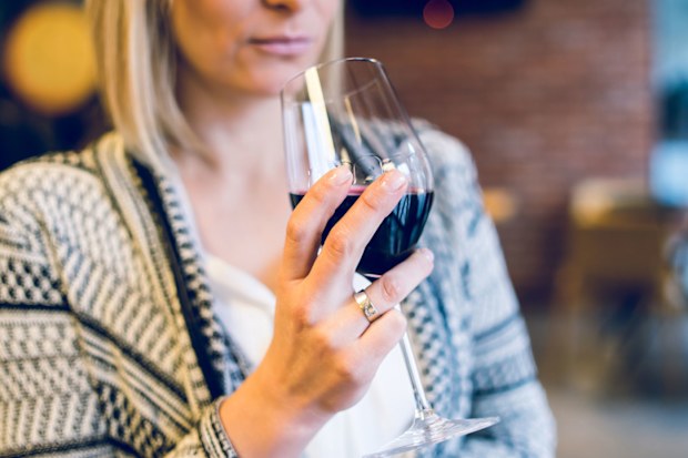 Woman drinking wine alone