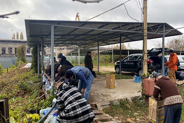 Kherson residents collect water from a well after Ukrainian forces liberated the city.