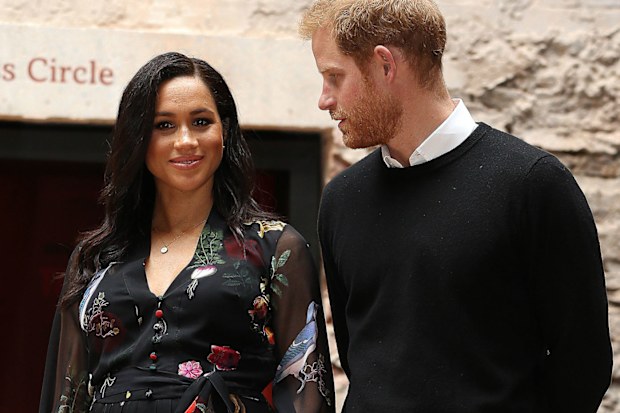 A sweet photo has emerged showing Prince Harry gazing at his wife, Meghan's, baby bump during a visit to Bristol.