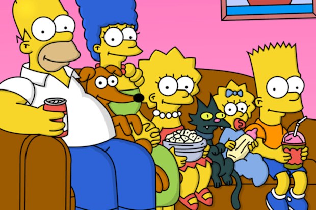 The Simpsons family sit on their couch