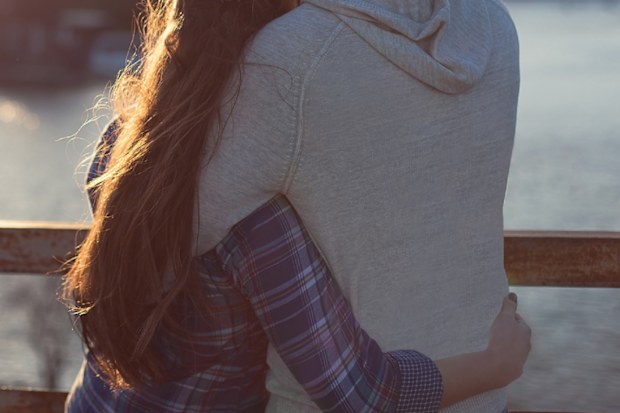 Young couple watching sunset.