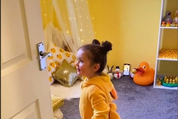 Toddler walking into her new duck-themed bedroom.