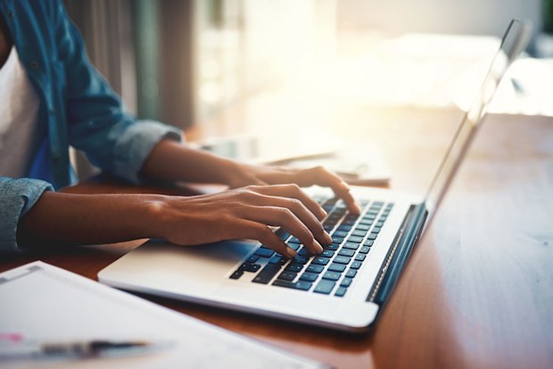 woman typing on laptop. 