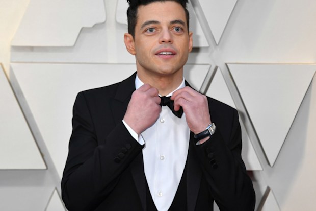 Rami Malek on the 2019 Oscars red carpet fixing his bow-tie