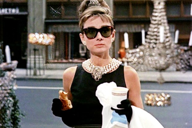 Audrey Hepburn wearing her little black dress, pearl jewelry and sunglasses in Breakfast at Tiffany's.