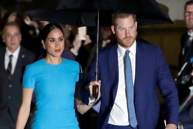 Harry and Meghan arrive at the annual Endeavour Fund Awards in London in the rain.