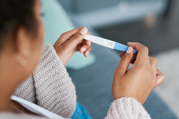 Woman looking at pregnancy test