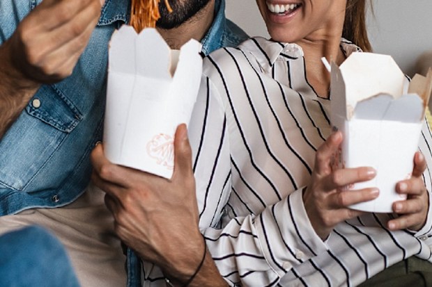 Couple at home eating takeaway