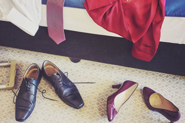 Clothes and shoes on floor next to bed.