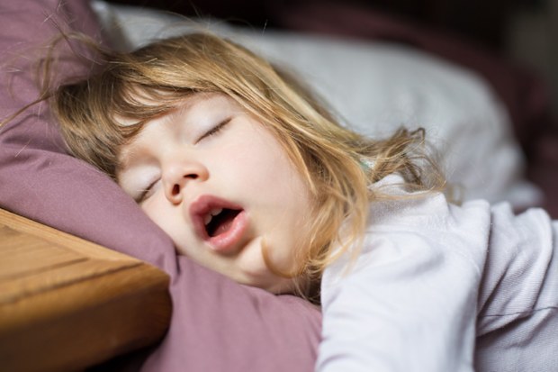 Toddler girl asleep in bed