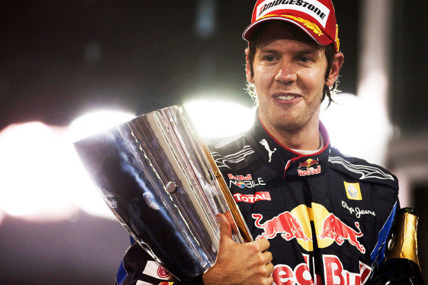 Sebastian Vettel poses with the trophy after winning the 2010 F1 world championship