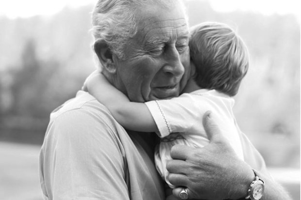Prince Charles hugging Prince Louis